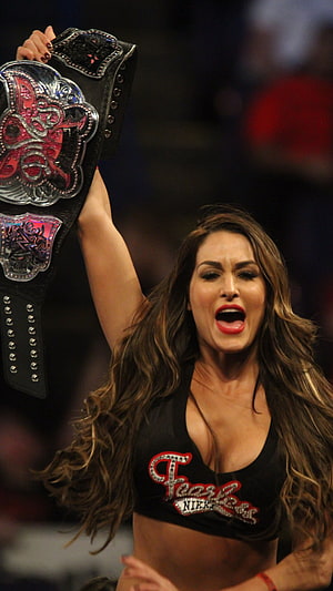 Nikki Bella Raising WWE Championship Belt in Victory Celebration HD phone wallpaper