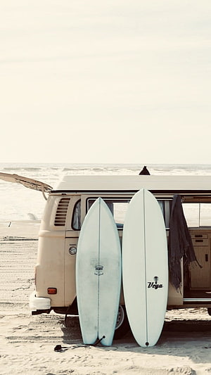 Vintage VW Camper Van with Surfboards on a Sunny Beach Shore HD phone wallpaper