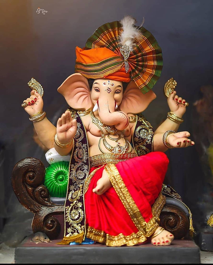 Lord Ganesha Murti in Ornate Red Dhoti and Gold Jewelry Seated on Carved Wooden Throne HD phone wallpaper