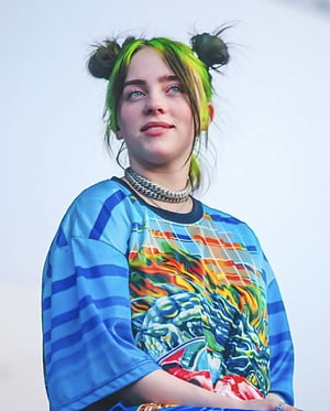 Billie Eilish Portrait With Green Hair Buns And Colorful Graphic Shirt HD phone wallpaper