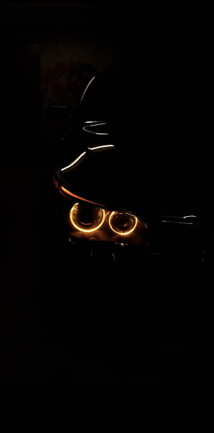 BMW E60 Headlight Close-Up with Glowing Angel Eyes in Dark Setting HD phone wallpaper