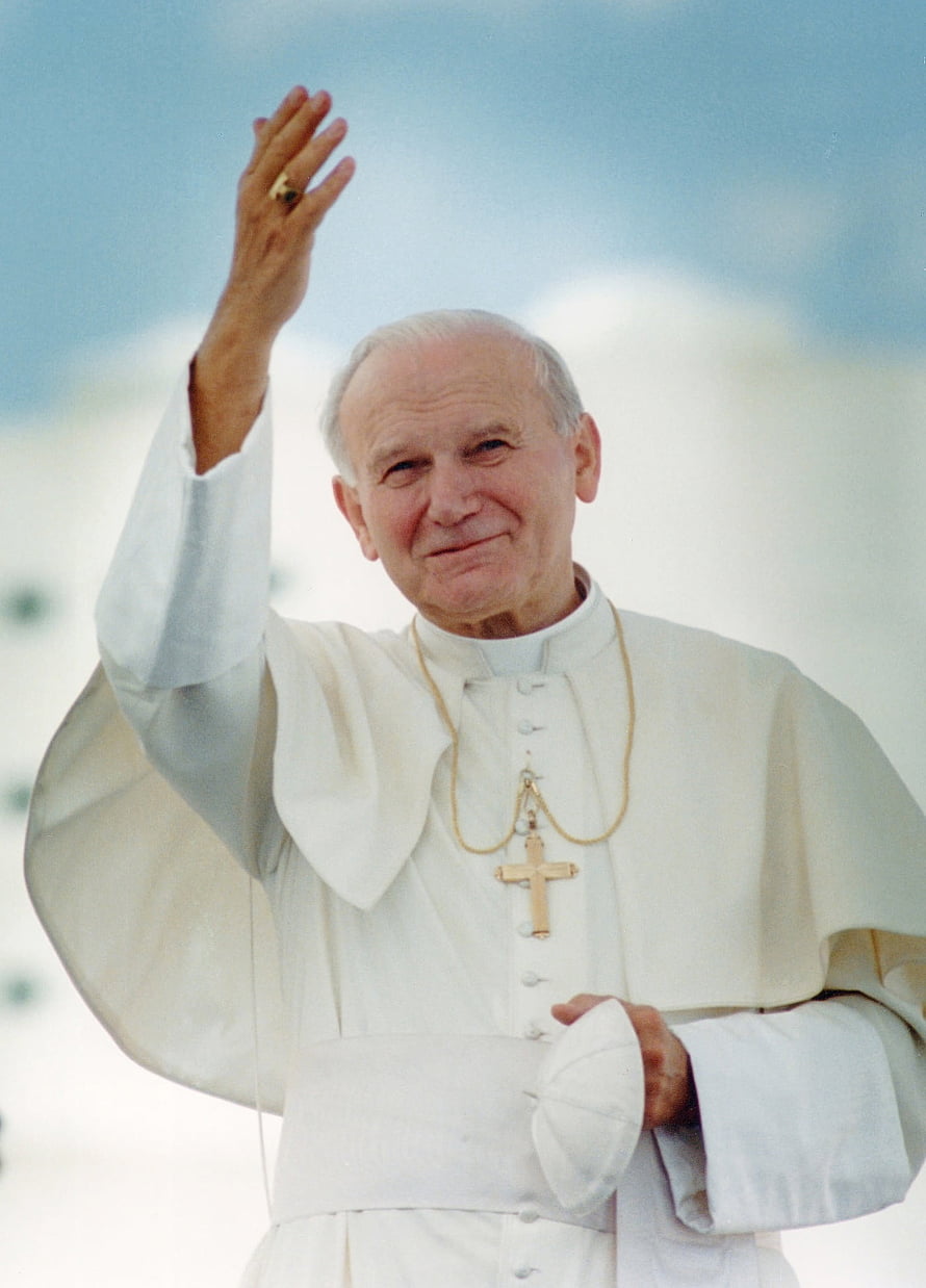 Pope John Paul II in white papal vestments waving with a golden pectoral cross against a bright sky HD phone wallpaper