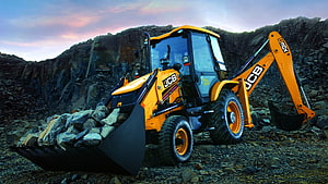 JCB 3DX Backhoe Loader Hauling Rocks in a Quarry at Sunset HD wallpaper
