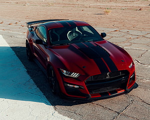 Red Ford Mustang Shelby GT500 with Black Racing Stripes on Desert Road HD wallpaper