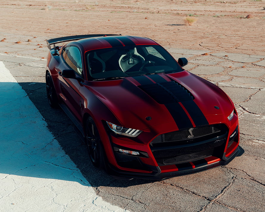 Red Ford Mustang Shelby GT500 with Black Racing Stripes on Desert Road HD wallpaper