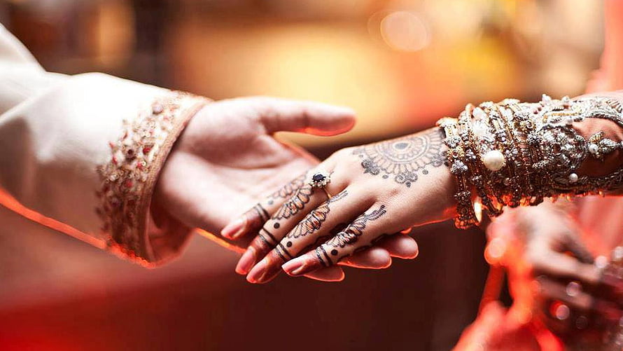Bride and Groom Hands Adorned with Henna and Jewelry During Indian Wedding Ceremony HD wallpaper