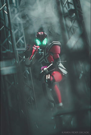 Kamen Rider Decade in Red and Black Armor Holding Card in Smoky Industrial Setting HD phone wallpaper