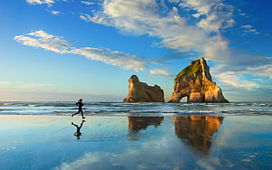 Runner on Wet Sand at Bandon Beach with Sea Stacks and Arch Reflections HD wallpaper