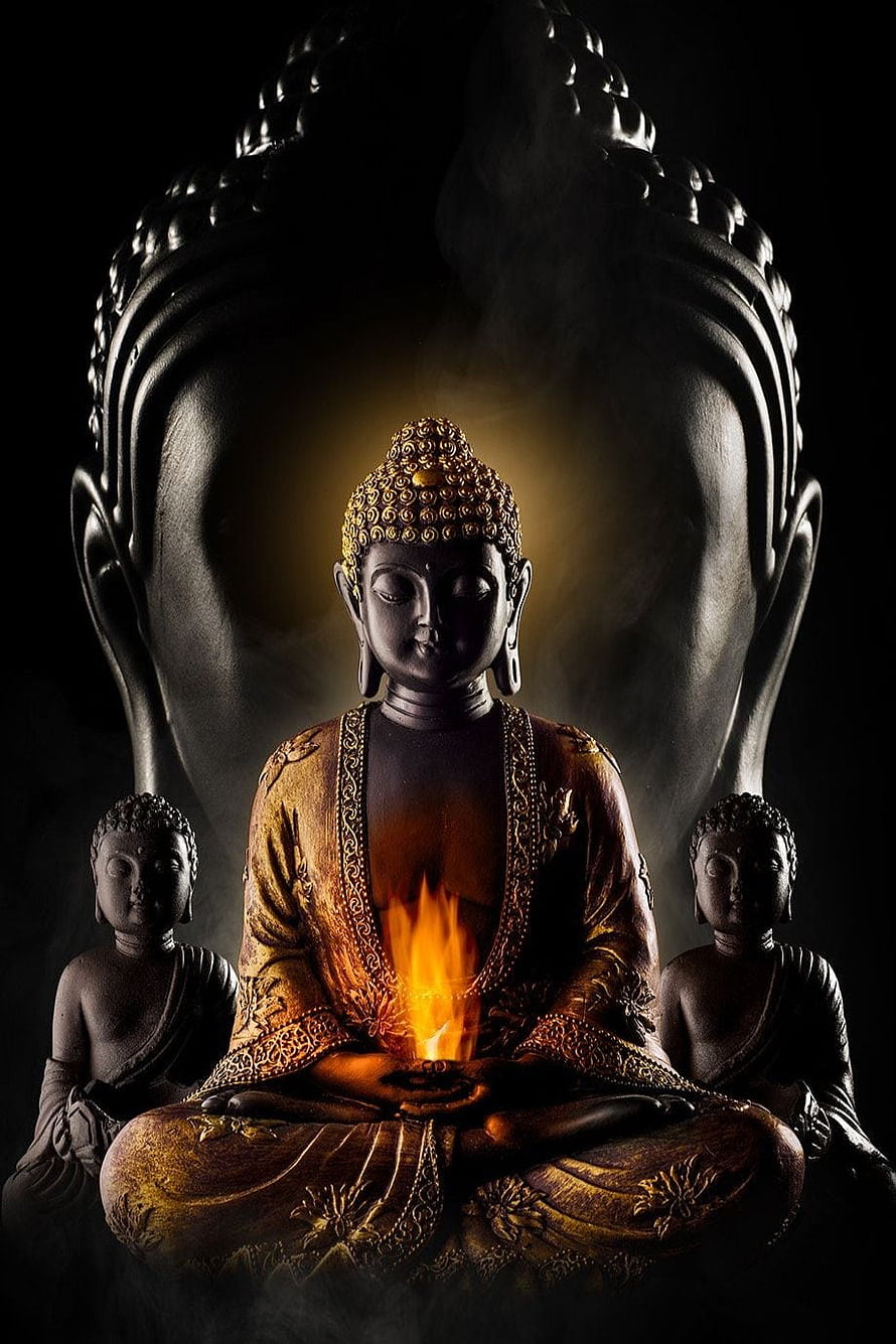 Meditating Buddha Statue with Inner Flame and Golden Aura in Dark Setting HD phone wallpaper