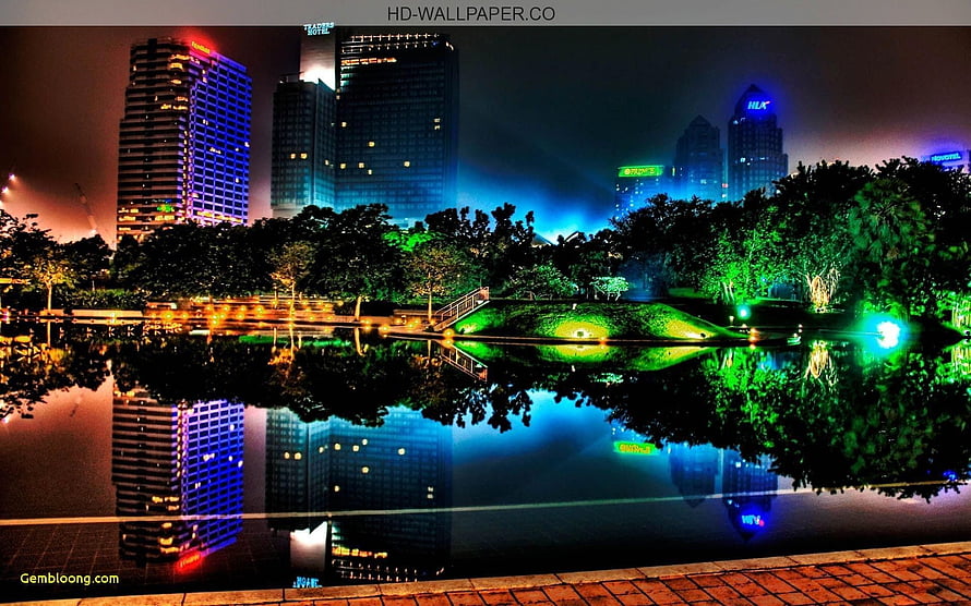 Vibrant Night Cityscape with Neon Reflections in a Park Lake HD wallpaper
