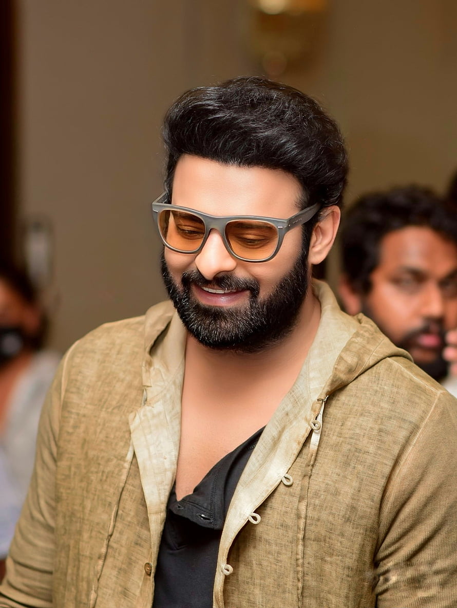 Prabhas Wearing Amber Tinted Glasses And Beige Hooded Jacket HD phone wallpaper