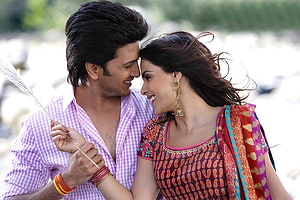 Romantic Indian couple in traditional attire sharing a tender moment outdoors HD wallpaper