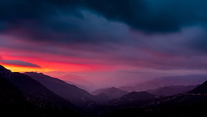 Dramatic Mountain Sunset with Fiery Red Sky and Dark Clouds HD wallpaper