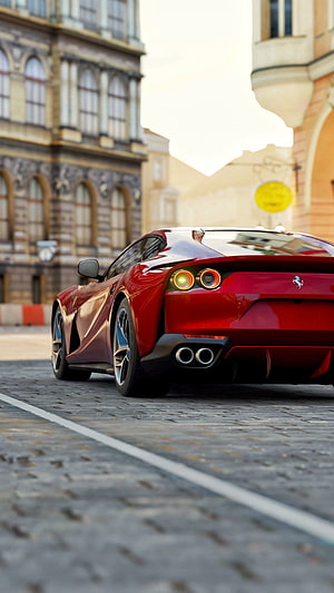 Rear View of a Red Ferrari 812 Superfast Parked on a Cobblestone Street in a European City HD phone wallpaper