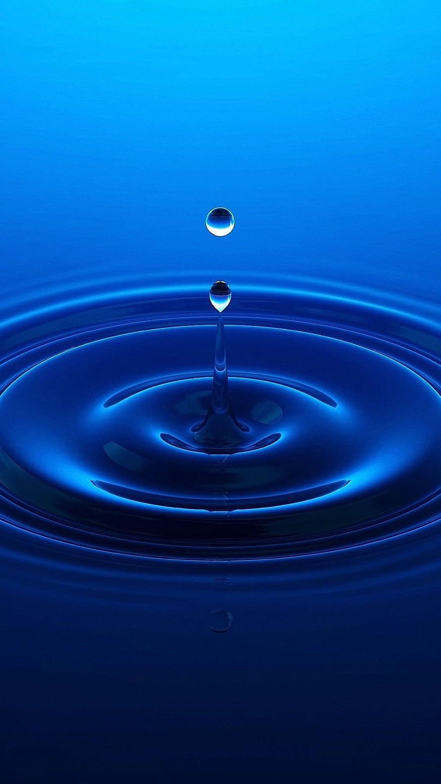 Vibrant Blue Water Droplet Ripples and Splash in Minimalist Macro Photography HD phone wallpaper