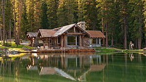 Rustic Log Cabin on a Serene Forest Lake with Perfect Reflections HD wallpaper