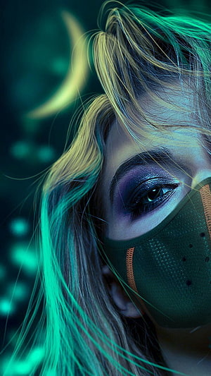 Close-up portrait of a woman wearing a face mask with dramatic purple eyeshadow and neon green lighting HD phone wallpaper