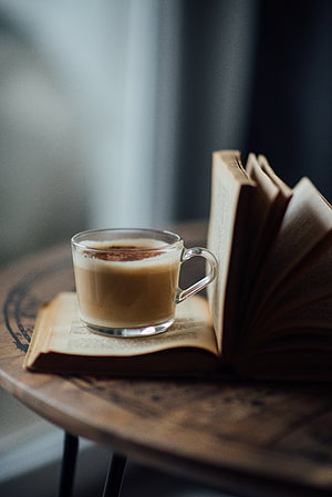 Cozy Morning Scene With Latte Art and Open Book on Rustic Wooden Table HD phone wallpaper