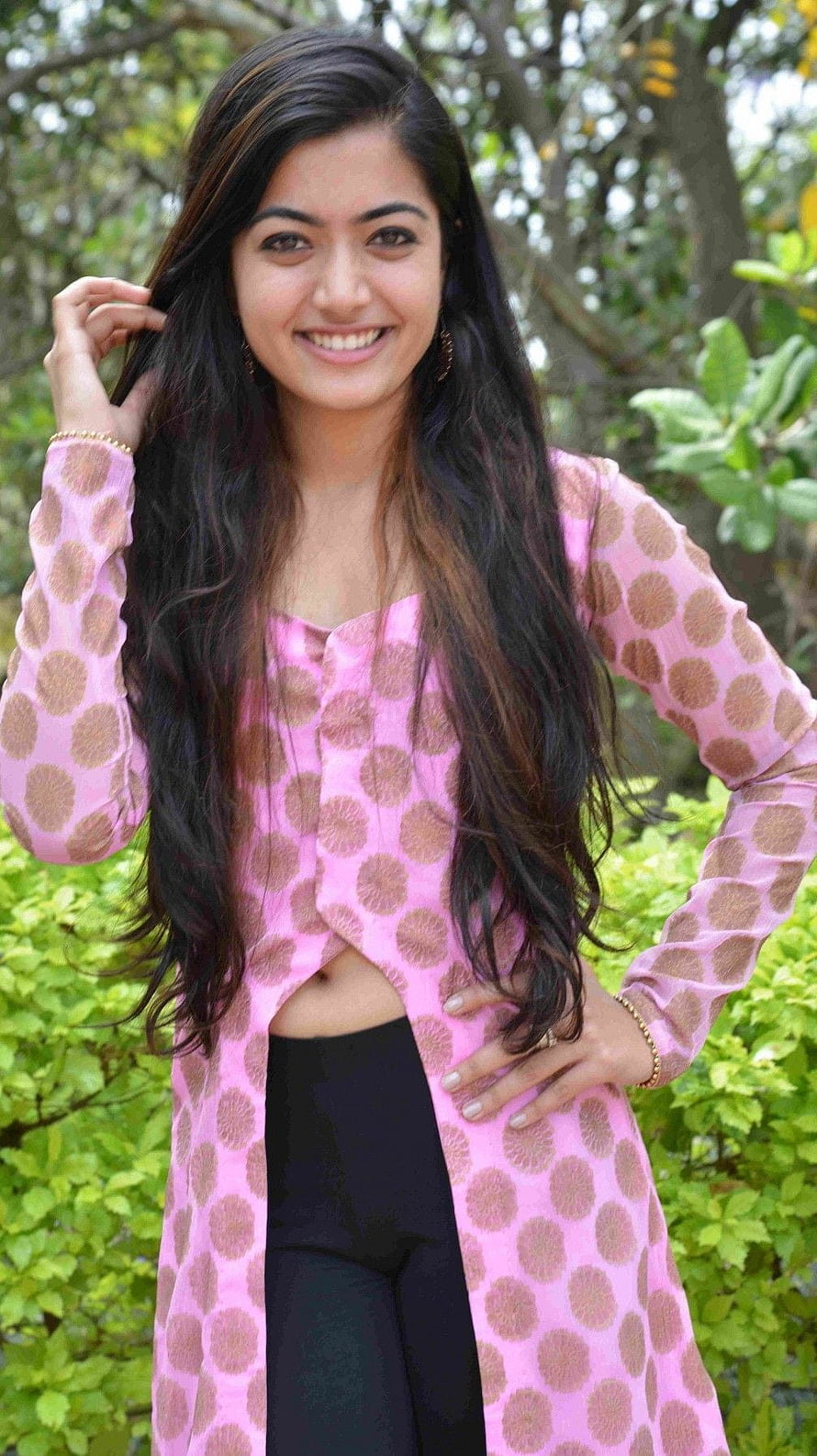 Rashmika Mandanna in a pink patterned kurta with black leggings outdoors HD phone wallpaper