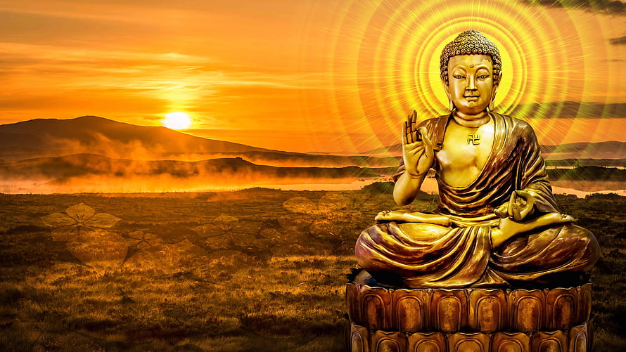 Gautam Buddha statue in meditation with golden halo against a warm sunset landscape HD wallpaper