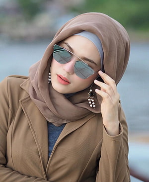 Elegant Woman in Brown Hijab and Sunglasses by the Water HD phone wallpaper