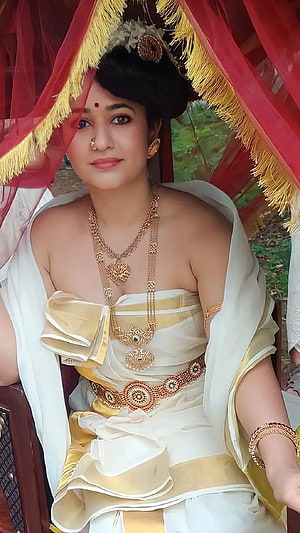 Poonam Bajwa in Traditional Kerala Attire with Gold Jewelry and Red Canopy HD phone wallpaper