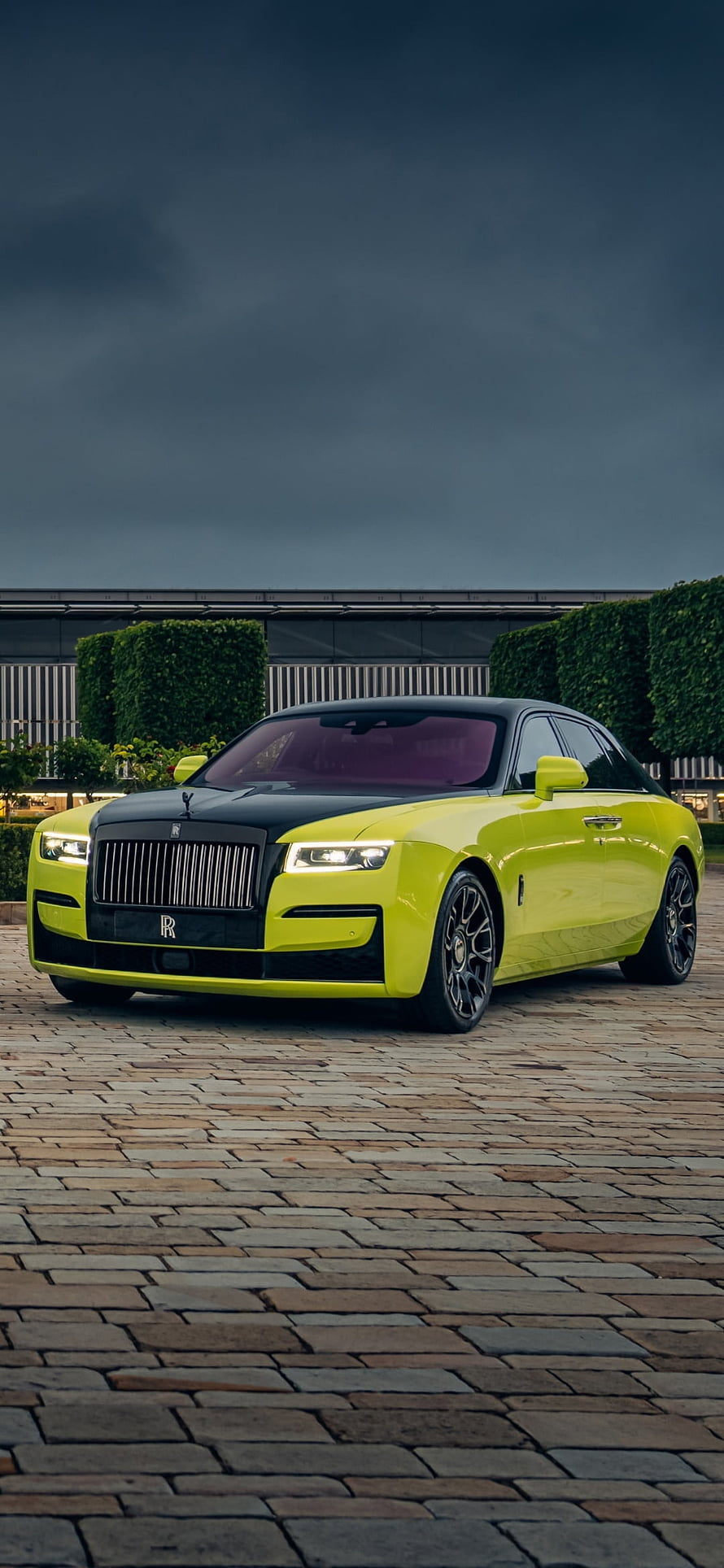 Lime Green Rolls-Royce Ghost with Black Hood Parked on Cobblestone Under Stormy Sky HD phone wallpaper