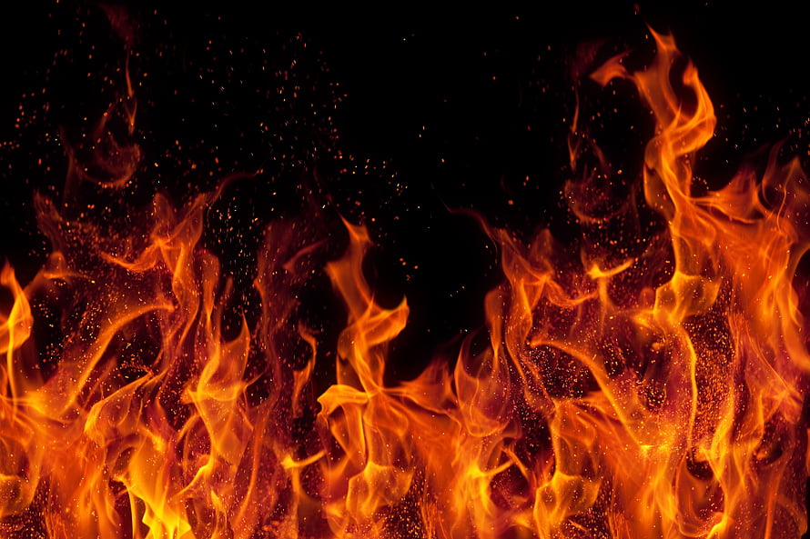 Vibrant Orange Flames and Glowing Embers Against a Deep Black Background HD wallpaper