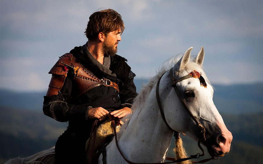 Ertugrul Gazi on horseback in medieval armor overlooking a mountainous landscape HD wallpaper