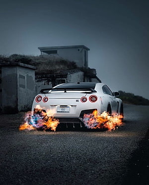 White Nissan GT-R R35 Rear View With Dramatic Exhaust Flames on a Dark Road HD phone wallpaper