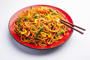 Stir-Fried Chow Mein Noodles with Colorful Bell Peppers and Chopsticks on a Red Plate HD wallpaper