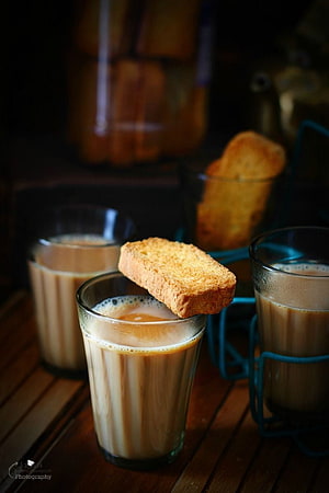 Authentic Indian Masala Chai with Toasted Biscuit on Wooden Table HD phone wallpaper