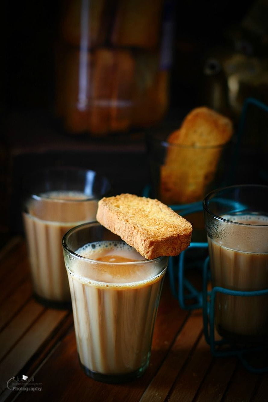 Authentic Indian Masala Chai with Toasted Biscuit on Wooden Table HD phone wallpaper