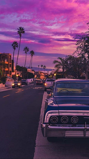 Vintage Chevrolet Classic Car Parked on Suburban Street Under Vibrant Purple Sunset Sky HD phone wallpaper