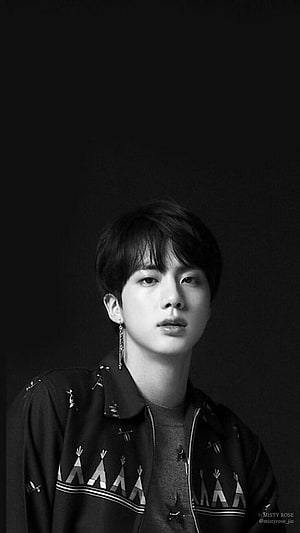 Jin from BTS in a moody black and white portrait wearing a patterned jacket HD phone wallpaper
