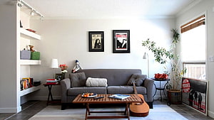 Modern Living Room Interior With Gray Sofa, Acoustic Guitar, And Framed Artwork HD wallpaper