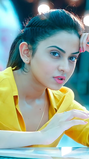 Rakul Preet Singh in a vibrant yellow blouse with a thoughtful expression and soft studio lighting HD phone wallpaper