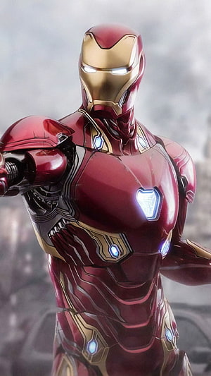 Iron Man Mark 85 Armor Close-Up with Glowing Arc Reactor and Gold Faceplate HD phone wallpaper
