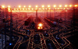 Indian Railways Junction at Dusk with Glowing Tracks and Overhead Lights HD wallpaper