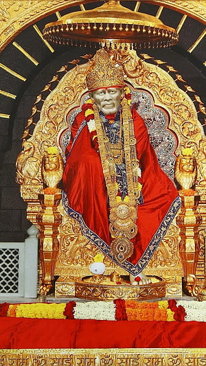Sai Baba Seated on Ornate Golden Throne in Red Robes and Jewels HD phone wallpaper