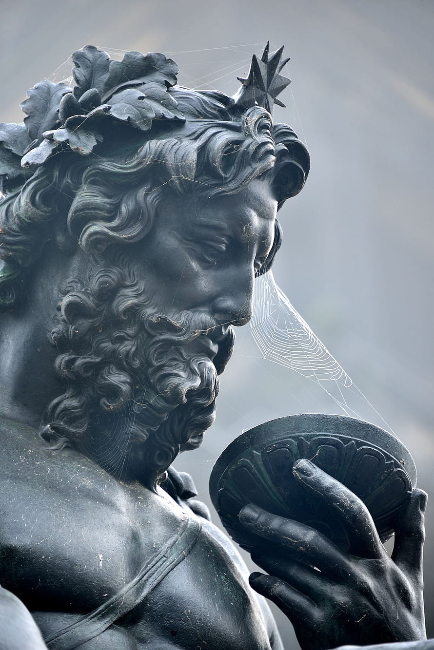 Close-up of a weathered Poseidon statue with laurel crown and spider webs HD phone wallpaper