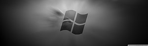 Windows 10 Monochrome Logo with Light Rays on Dark Gradient Background HD wallpaper