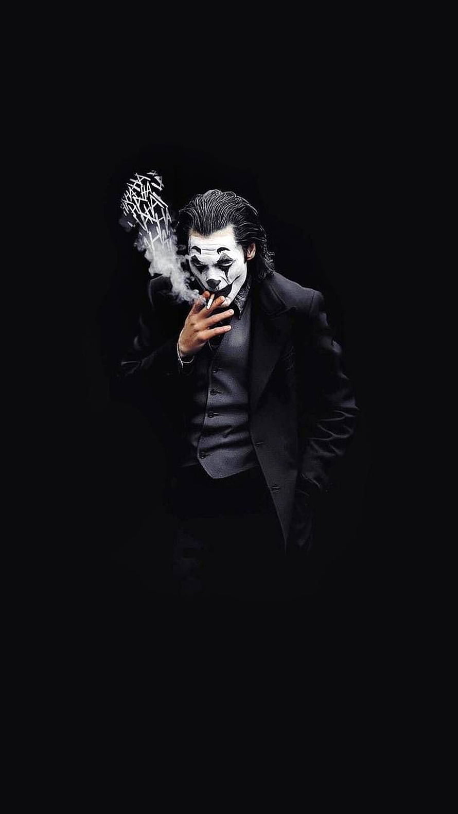 Joker in a black suit smoking a cigarette against a dark background HD phone wallpaper