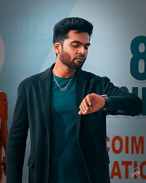 Maanaadu Teaser Still of Actor in Dark Blazer Checking Watch HD phone wallpaper