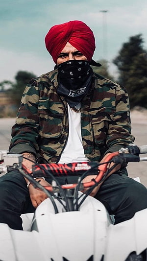 Sidhu Moose Wala in Red Turban and Camouflage Jacket on Motorcycle HD phone wallpaper
