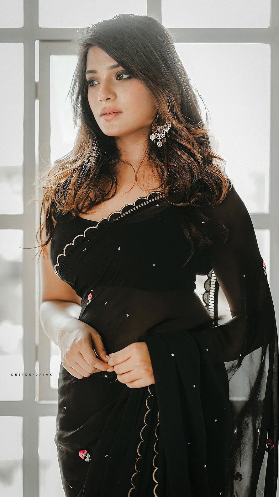 Aathmika in an elegant black embroidered saree with scalloped neckline and traditional jhumka earrings HD phone wallpaper