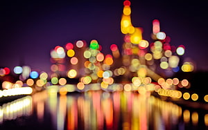 Colorful Bokeh City Lights Reflected on Water at Night HD wallpaper