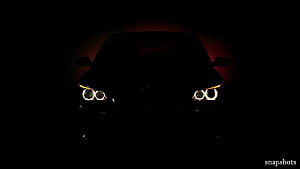 BMW M5 E60 Front Headlights Glowing in Darkness with Dramatic Red Backlight HD wallpaper