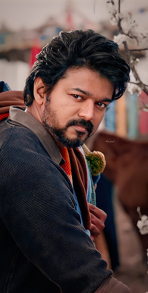 Thalapathy Vijay in a textured dark jacket with a serious expression and styled hair HD phone wallpaper