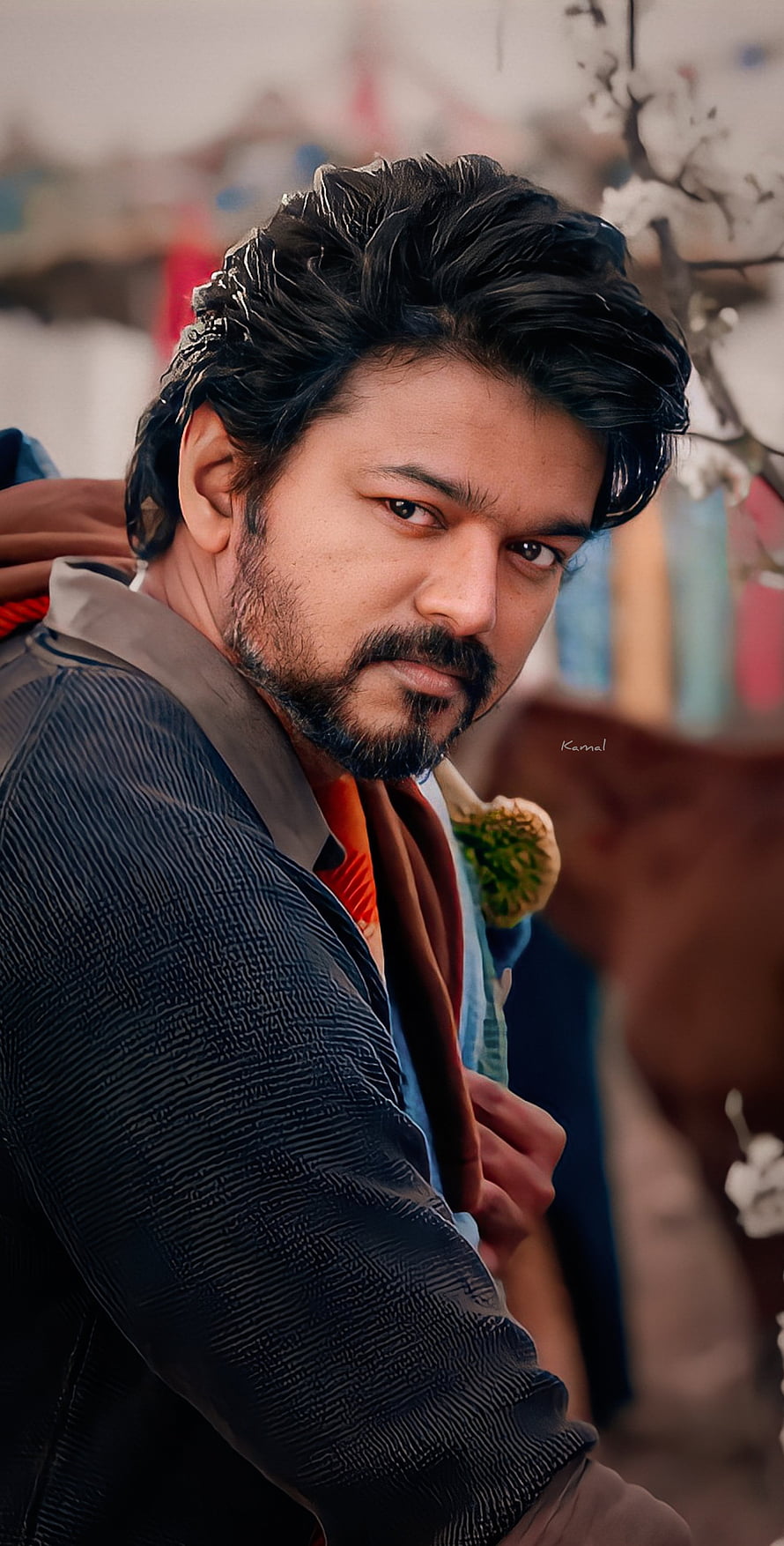 Thalapathy Vijay in a textured dark jacket with a serious expression and styled hair HD phone wallpaper
